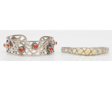 A silver and opal set bangle, sprung on one side and a silver and coral bangle, 61gm 