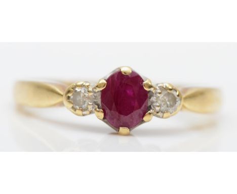 A 9ct gold ruby and brilliant cut diamond three stone ring, J, 1.4gm 