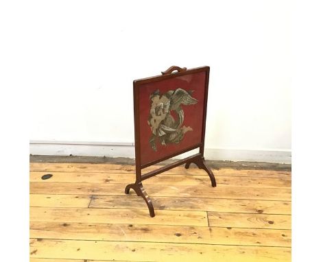 An early 20thc wooden framed firescreen, the rectangular beadwork banner with a depiction of an Angel embracing two Children,