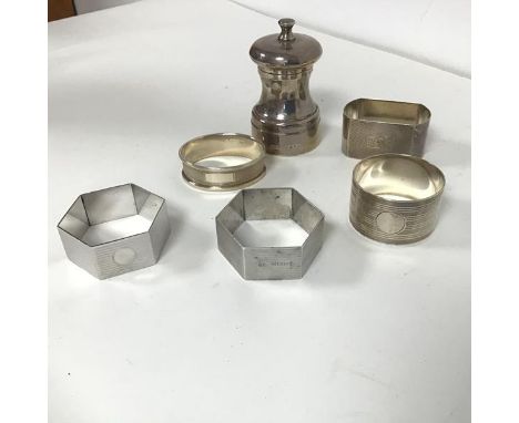 An assortment of five Birmingham silver napkin rings all with engine turned decoration by various makers (94.21g) and a Londo