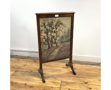 A 1930s burr walnut framed firescreen, the rectangular frame with moulded top enclosing a grospoint tapestry banner by Quenti