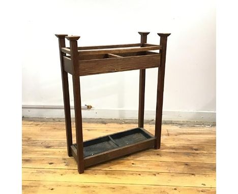 An Arts &amp; Crafts stick stand, c.1900, the rectangular frame with projecting finials, single division and detachable paint