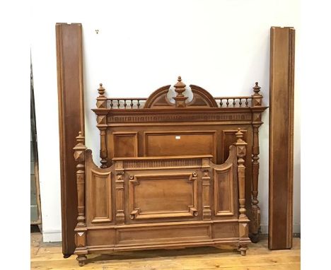 A French walnut three quarter bed, c.1900, the headboard with central urn finial above a fluted frieze and panel front, the f