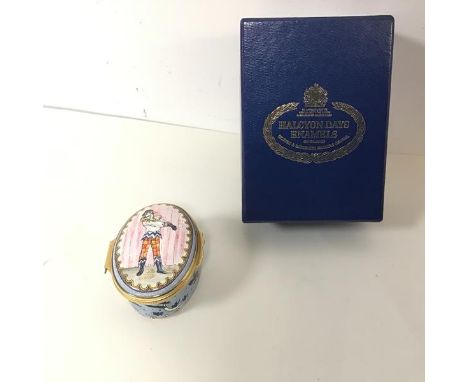 A Halcyon Days enamel musical box, the lid decorated with a clown, the hinged top opens to reveal the music mechanism and an 