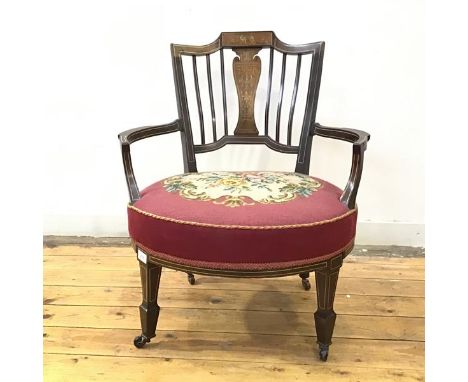 A late Victorian walnut boxwood and bone inlaid tub chair in the Neoclassical taste, the tablet top rail and baluster shaped 