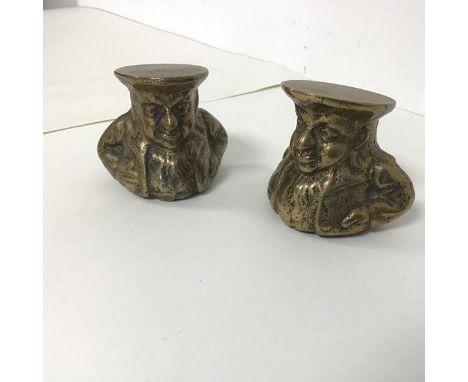 A pair of brass sash window stops in the form of Portly Gentlemen with Hats (each measuring h.6cm x 7cm x 5cm)