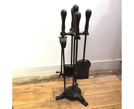 A modern set of fire tools including shovel, brush, tongs and poker, all on stand, stamped 1880, painted black (60cm x 24cm)