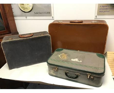 A set of three vintage travel cases, including one of brown treated leather, blue canvas and green striped vinyl (largest: 48