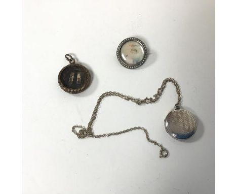 A 19thc portrait brooch on ivory mounted within a circular frame marked 900 with a border of seed pearls (d.2.5cm), a locket 