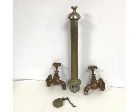 A pair of 19thc copper taps with enamel top and plug and cylindrical plug attachment