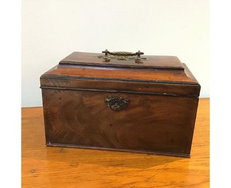 A George III mahogany tea caddy, the rectangular hinged top opens to reveal two tea cannisters, and central bowl recess, with