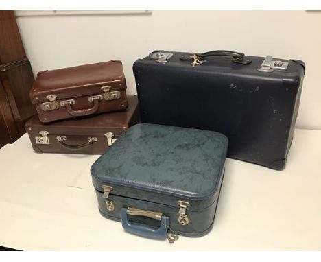 Four vintage travel cases, including two brown leather cases, one blue vinyl and one square imitation leather in teal (larges