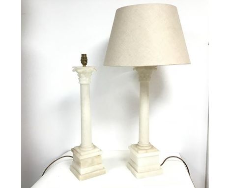 A pair of alabaster Corinthian column style table lamps, the capitals over plain columns, on a moulded and multiple tiered sq