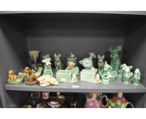 20th century Sylvac and Wade figures including pipe holders, green glaze dogs and similar