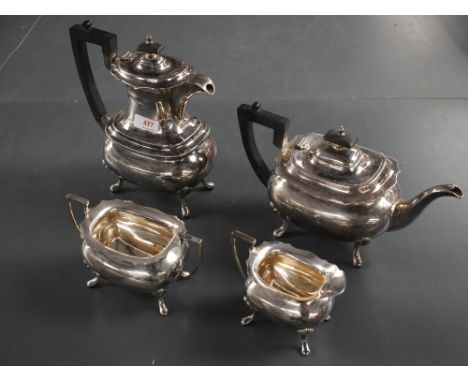 A George V silver four-piece silver teaset, comprising hotwater pot, teapot, sugar and cream, of moulded oval form with shape