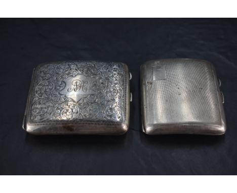 A George V silver cigarette case, of hinged rectangular form, curved for the gentleman's pocket and engraved with foliate scr