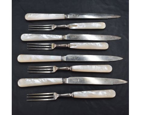 A group of George V Mother-of-Pearl handled silver dessert cutlery, comprising four three tined forks and four silver bladed 