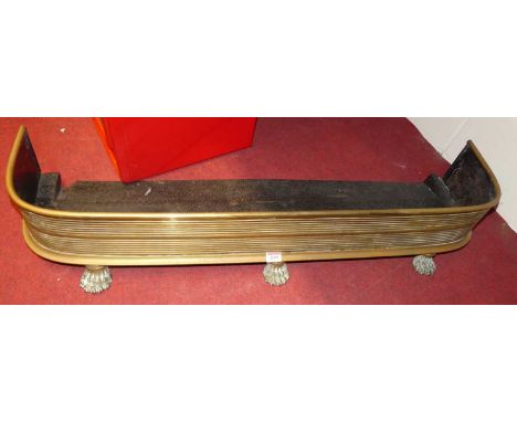 A 19th century brass fire fender, standing on three lion paw feet, w.100cm