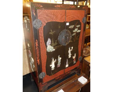 A contemporary Chinese black lacquered hardstone inset low double door side cupboard, w.61.5cm 