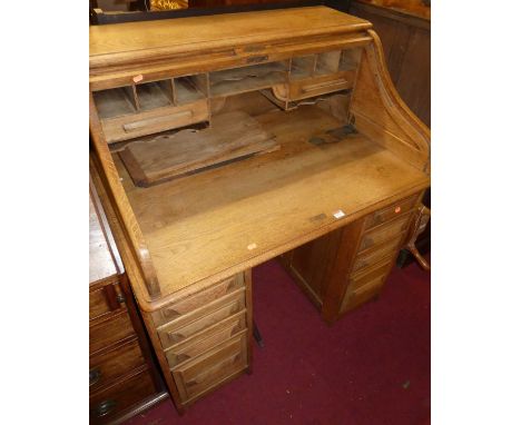 An early 20th century light oak kneehole rolltop desk, w.106cm 