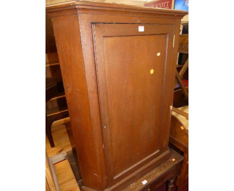 A 19th century oak low single door corner cupboard