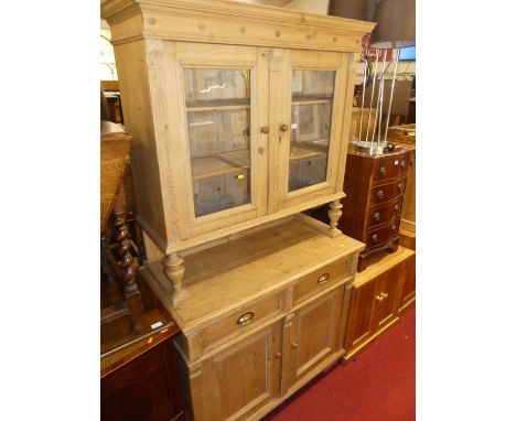 A rustic reclaimed pine French kitchen dresser, having twin door glazed upper section over base fitted with single pull-out s