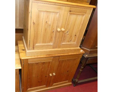 Three various modern pine low double door side cupboards, the largest width 91cm