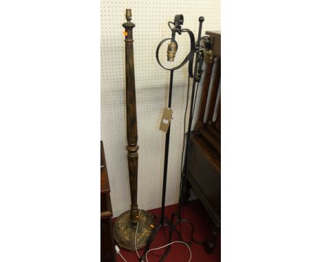 Two similar black painted wrought iron standard lamps, together with a fluted stained wood standard lamp (3)