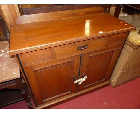 An Edwardian oak ledgeback double door side cupboard, having single frieze drawer, width 107cm