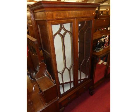 A mahogany and inlaid double door glazed china display cabinet, having twin short lower drawers on squat cabriole supports, w