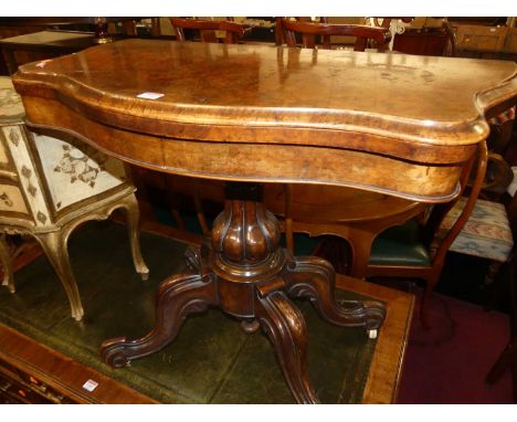 A mid-Victorian figured walnut serpentine front fold-over baize lined card table, raised on bulbous reeded support to hipped 