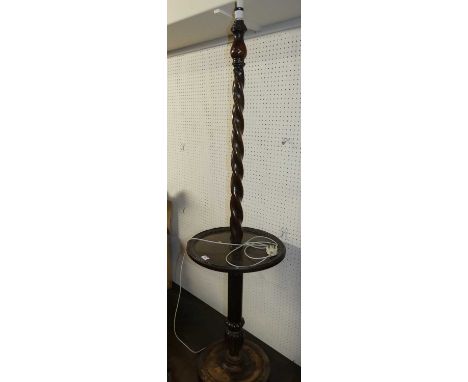 An early 20th century barley twist turned oak standard lamp, with dished centre tier