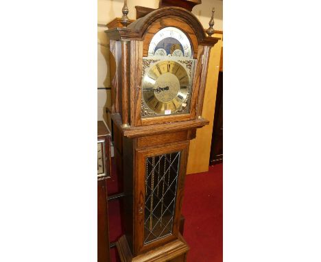 A contemporary Fenclocks of Suffolk, oak longcase clock having an arched moon phase brass dial, triple weight driven movement