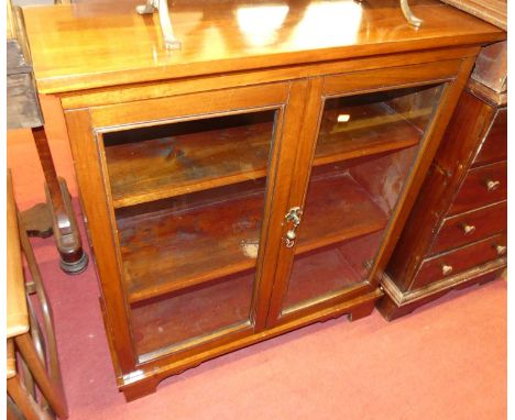 An early 20th century mahogany and stained pine low double door glazed bookcase, width 84cm