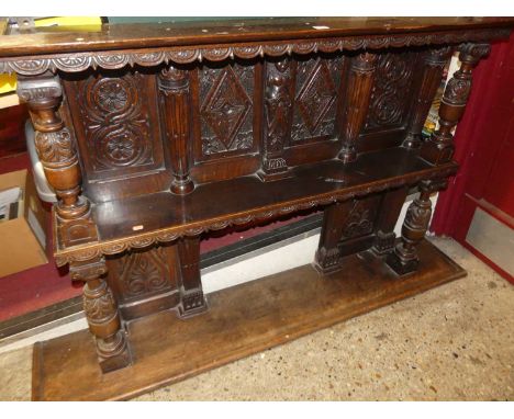 A relief joined and carved oak panelled wall mounted two-tier wall shelf, 101.5 x 168cm 