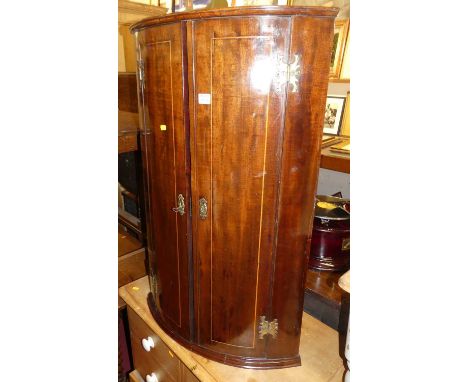 A 19th century mahogany bowfront double door hanging corner cupboard, height 97cm