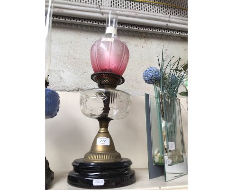 Brass and glass oil lamp with pink shadeCondition: small nibble to base rim of pink shade, rest of glass ok, no cracks or rep