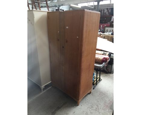 An Austinsuite light oak fitted wardrobe 