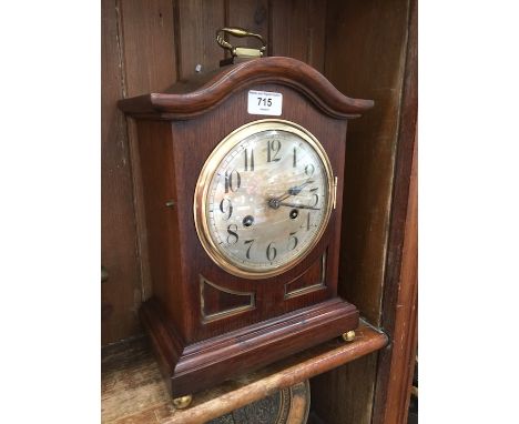 An oak mantel clock with brass handle and movement. Circa 1900 