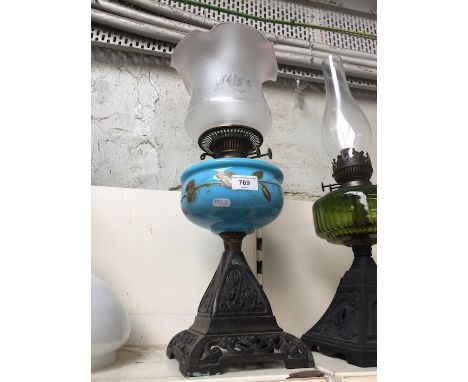 cast base and blue glass oil lamp with etched shade 