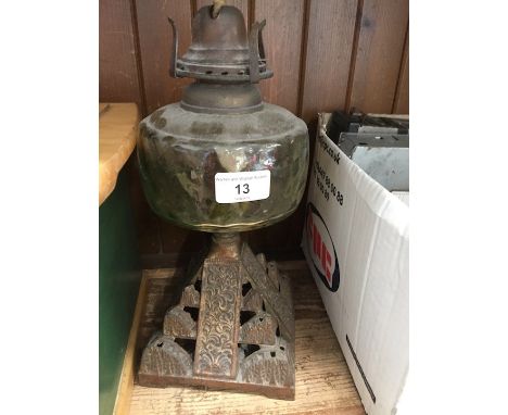 A parafin lamp having cast iron pyramid style base and amber glass basin - no shade &amp; funnel 
