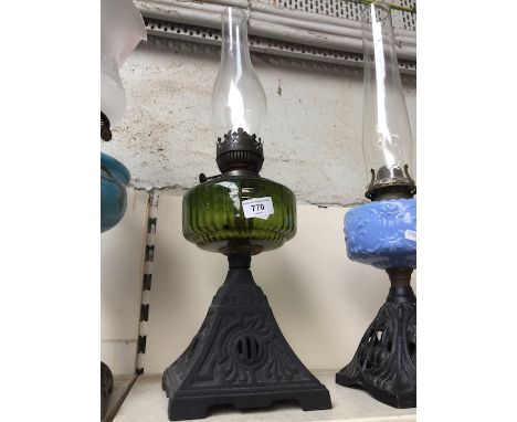 Cast base and green glass oil lamp with funnel 