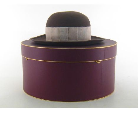A lady’s light brown wide brim bowler style hat with broad ecru band by Herbert Johnson, New Bond Street, in original hatbox 