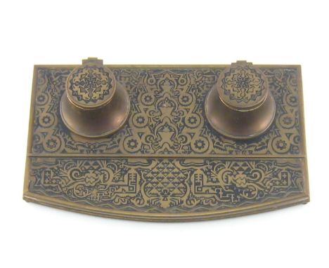 A two well rectangular brass inkstand with curved front, circa 1930, with pen tray on ball feet the whole inset with unusual 