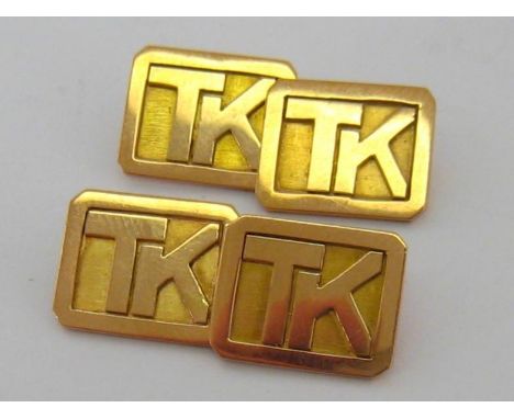 A pair of yellow metal (tests 9 carat gold) cufflinks, the links with raised initials 'TK' on a canted rectangular ground, ch