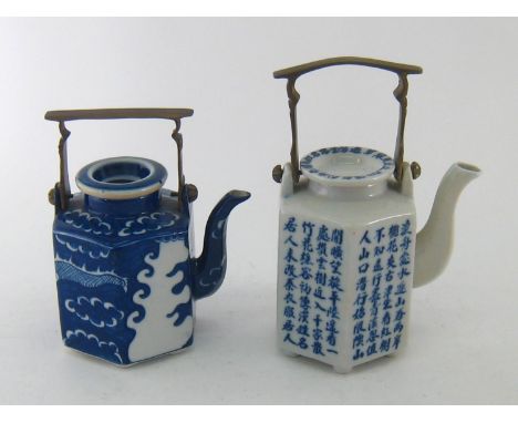 Two Chinese hexagonal ceramic teapots in blue and white with brass handles, one with Chinese script on all sides, the other d