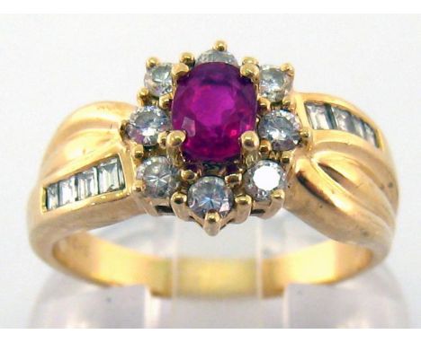 A ruby and diamond cluster ring, the central oval cut ruby approx. 0.48 carat, in a surround of brilliants, totalling approx.