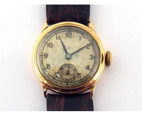 A 1930s 9 carat gold manual wind wristwatch, the two piece hinged case hallmarked Birmingham 1939, the two toned silver dial 