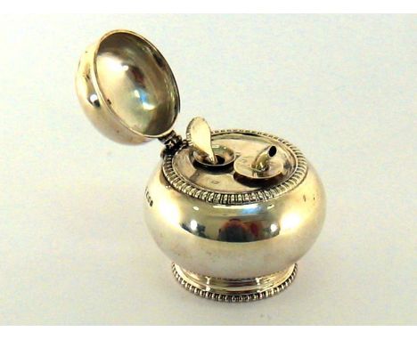 A silver table spirit lighter by Henry &amp; Arthur Vander, London, 1925, squat circular with hinged cover and gadroon border