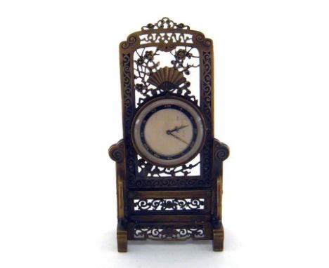 An Oriental brass eight day mantel clock cast and pierced with traditional fan, prunus blossom and scrolling, the dial with r